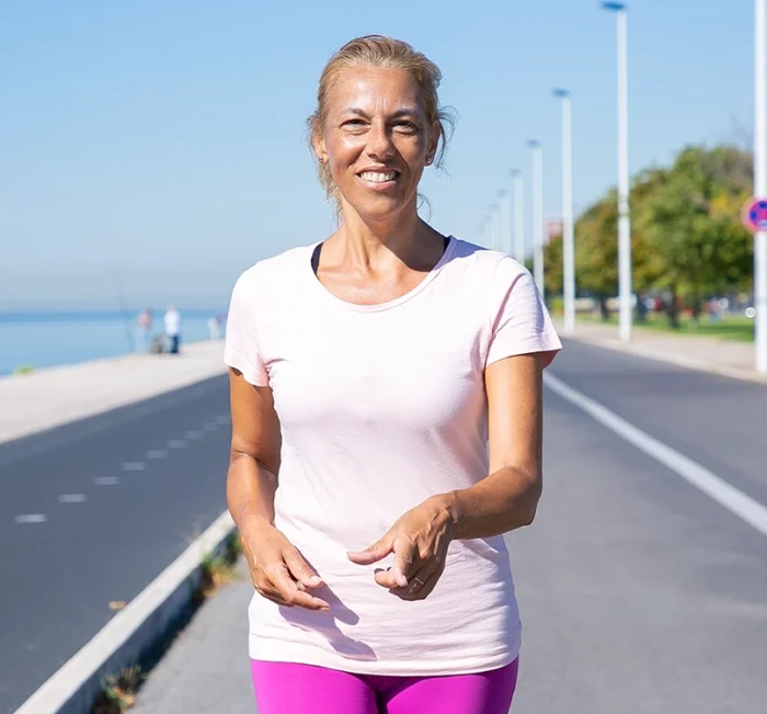 Woman walking outdoors to represent healthy weight and wellness support.
